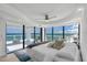 Bright main bedroom with a ceiling fan, balcony access, and stunning ocean views at 3000 N Atlantic Ave # 24, Daytona Beach, FL 32118
