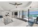 Bright main bedroom boasting large windows with a view and easy access to the balcony at 3000 N Atlantic Ave # 24, Daytona Beach, FL 32118