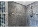 Modern shower stall featuring multicolored mosaic tiling and contemporary fixtures at 3000 N Atlantic Ave # 24, Daytona Beach, FL 32118