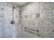 Tastefully tiled shower with a rainfall shower head and grab bar for safety at 3000 N Atlantic Ave # 24, Daytona Beach, FL 32118