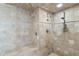 Custom tiled walk-in shower with dual shower heads and a built-in bench at 3000 N Atlantic Ave # 24, Daytona Beach, FL 32118