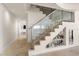 Modern staircase with glass railings, display shelves and climate controlled wine storage at 3000 N Atlantic Ave # 24, Daytona Beach, FL 32118