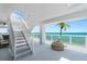 Stairwell with potted palm and ocean view, leading to beachfront patio at 3000 N Atlantic Ave # 24, Daytona Beach, FL 32118