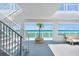 Open-air stairwell leading to beachfront patio, featuring a potted palm and sitting area at 3000 N Atlantic Ave # 24, Daytona Beach, FL 32118