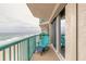Relaxing balcony with blue chair overlooking the beach at 3315 S Atlantic Ave # 1106, Daytona Beach, FL 32118