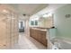 Well-appointed bathroom with double sinks, soaking tub, and a walk-in shower at 3315 S Atlantic Ave # 1106, Daytona Beach, FL 32118