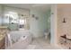 Bathroom features a large soaking tub, walk-in shower and neutral tiling at 3315 S Atlantic Ave # 1106, Daytona Beach, FL 32118