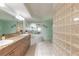 Luxurious bathroom boasts double sinks, granite countertops, and a tiled tub with jets at 3315 S Atlantic Ave # 1106, Daytona Beach, FL 32118