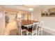 Bright dining area with a large wooden table, seating for eight, and artwork featuring sailboats at 3315 S Atlantic Ave # 1106, Daytona Beach, FL 32118