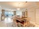 Well-lit dining area with seating for six and ocean views through a sliding glass door at 3315 S Atlantic Ave # 1106, Daytona Beach, FL 32118