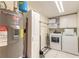 Functional laundry room equipped with a washer, dryer, and ample storage space at 3315 S Atlantic Ave # 1106, Daytona Beach, FL 32118