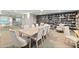Bright library area with a large table, comfortable seating, and extensive bookshelves lining the walls at 3315 S Atlantic Ave # 1106, Daytona Beach, FL 32118