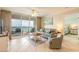 Relaxing living room featuring a large sliding glass door leading to a balcony and ocean views at 3315 S Atlantic Ave # 1106, Daytona Beach, FL 32118