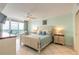 Relaxing bedroom featuring tiled floors, access to a private balcony, and comfortable furnishings at 3315 S Atlantic Ave # 1106, Daytona Beach, FL 32118