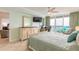 Inviting bedroom featuring private balcony access, a work space, and beachy decor at 3315 S Atlantic Ave # 1106, Daytona Beach, FL 32118