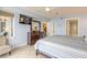 Comfortable bedroom featuring tiled floors, a balcony, and a flat-screen TV at 3315 S Atlantic Ave # 1106, Daytona Beach, FL 32118