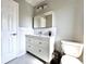 Modern bathroom featuring a white vanity, subway tile backsplash and a mirrored medicine cabinet at 3354 Hamlet Loop, Winter Park, FL 32792