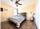 Bedroom with wood-look floors, fan, and a bedside table lamp for reading at 3354 Hamlet Loop, Winter Park, FL 32792