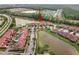 Scenic aerial view of townhomes surrounded by lush landscaping and tranquil lakes at 3613 Casalta Cir, New Smyrna Beach, FL 32168