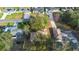 Aerial view shows the property in relationship to the surrounding neighborhood and mature trees at 370 Charles Ave, Orange City, FL 32763