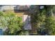 An aerial view shows the property's layout, including the landscaping, roof and proximity to a neighborhood pool at 370 Charles Ave, Orange City, FL 32763