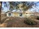 A backyard featuring a patio and lush, mature landscaping with trees creating a serene outdoor space at 370 Charles Ave, Orange City, FL 32763