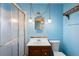 Charming bathroom with a vanity, glass shower doors, and unique hanging light fixtures at 370 Charles Ave, Orange City, FL 32763