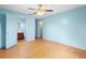 Bright bedroom with an ensuite bathroom, ceiling fan, and wood-look floors at 370 Charles Ave, Orange City, FL 32763