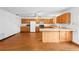 Open concept kitchen with breakfast bar, wood cabinets and appliances at 370 Charles Ave, Orange City, FL 32763