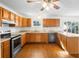 Charming kitchen featuring stainless steel appliances, wood floors, and ample cabinet space at 370 Charles Ave, Orange City, FL 32763