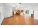 Bright living room featuring hardwood floors, ceiling fans, and open layout to kitchen at 370 Charles Ave, Orange City, FL 32763