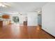 Open-concept living area featuring hardwood floors, ceiling fans, and access to the kitchen at 370 Charles Ave, Orange City, FL 32763