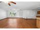 Spacious living room featuring wood floors, a ceiling fan, and natural light from large windows at 370 Charles Ave, Orange City, FL 32763