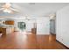 Bright living room with hardwood floors, ceiling fans, and a view of the kitchen at 370 Charles Ave, Orange City, FL 32763