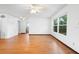 Open living room with hardwood floors, a ceiling fan, and natural light from a large window at 370 Charles Ave, Orange City, FL 32763