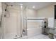 Modern bathroom featuring enclosed shower, bathtub, and shelving at 4 Oceans West Blvd # 601A, Daytona Beach Shores, FL 32118
