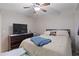 Cozy bedroom features ceiling fan, queen sized bed, and dresser at 4 Oceans West Blvd # 601A, Daytona Beach Shores, FL 32118