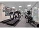 Bright fitness center with treadmills, elliptical machines, mirrored walls and windows overlooking exterior at 4 Oceans West Blvd # 601A, Daytona Beach Shores, FL 32118