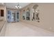Inviting hallway area featuring tiled floor, mirrors and access to lobby at 4 Oceans West Blvd # 601A, Daytona Beach Shores, FL 32118