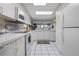 Bright kitchen with white cabinetry and tiled floor, open to adjacent living space at 4 Oceans West Blvd # 601A, Daytona Beach Shores, FL 32118