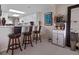 Living area with breakfast bar seating open to kitchen and bar at 4 Oceans West Blvd # 601A, Daytona Beach Shores, FL 32118