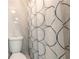 Updated bathroom with white tile, new toilet, and modern shower curtain at 408 Wisteria Rd, Daytona Beach, FL 32118