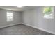 Bedroom with new plank flooring, fresh paint, and bright windows to let in natural light at 408 Wisteria Rd, Daytona Beach, FL 32118