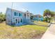 View of the backyard featuring a well-maintained lawn and access to the home at 408 Wisteria Rd, Daytona Beach, FL 32118