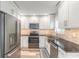 Modern kitchen featuring stainless steel appliances, white cabinets, and a stylish backsplash at 408 Wisteria Rd, Daytona Beach, FL 32118