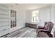A cozy living room area with wood plank floors, built in shelving and a comfortable chair at 408 Wisteria Rd, Daytona Beach, FL 32118