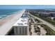 Aerial view of a beachfront condo building with on-site parking, showcasing proximity to the beach and other local attractions at 4631 S Atlantic S Ave # 8201, Ponce Inlet, FL 32127