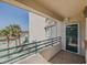 Relaxing balcony area featuring a secure railing and a charming view of palm trees and parking at 4631 S Atlantic S Ave # 8201, Ponce Inlet, FL 32127