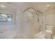 This bathroom offers a glass-enclosed shower, bathtub, and a toilet at 4631 S Atlantic S Ave # 8201, Ponce Inlet, FL 32127