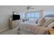 Coastal bedroom featuring ocean views from the balcony, ample natural light, and a comfortable desk area for work or study at 4631 S Atlantic S Ave # 8201, Ponce Inlet, FL 32127